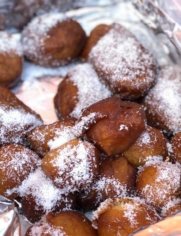Traditional Cape Malay koeksisters covered in honey and coconut flakes