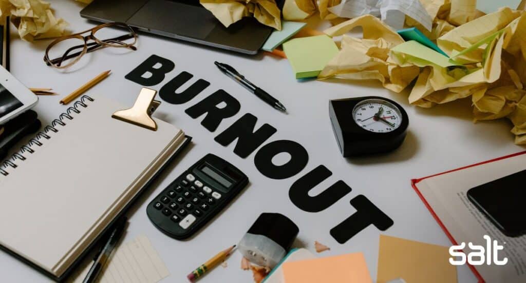Burnout written on a desk with lots of papers and mess surrounding it