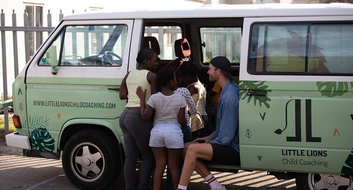 Stijn Co-founder of Little Lions interacting with kids within the community in the Little Lions mini van