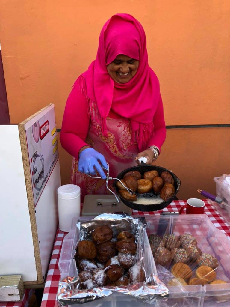 Bo-Kaap business women Wardia basting her appetizing traditional Cape Malay koeksisters in hot honey for serving