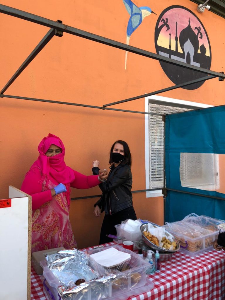 Bo-Kaap Business Wardia owner and Salt South Africa's operations manager Danica enjoying a laugh and conversation while greeting each other and observing social distancing rules.