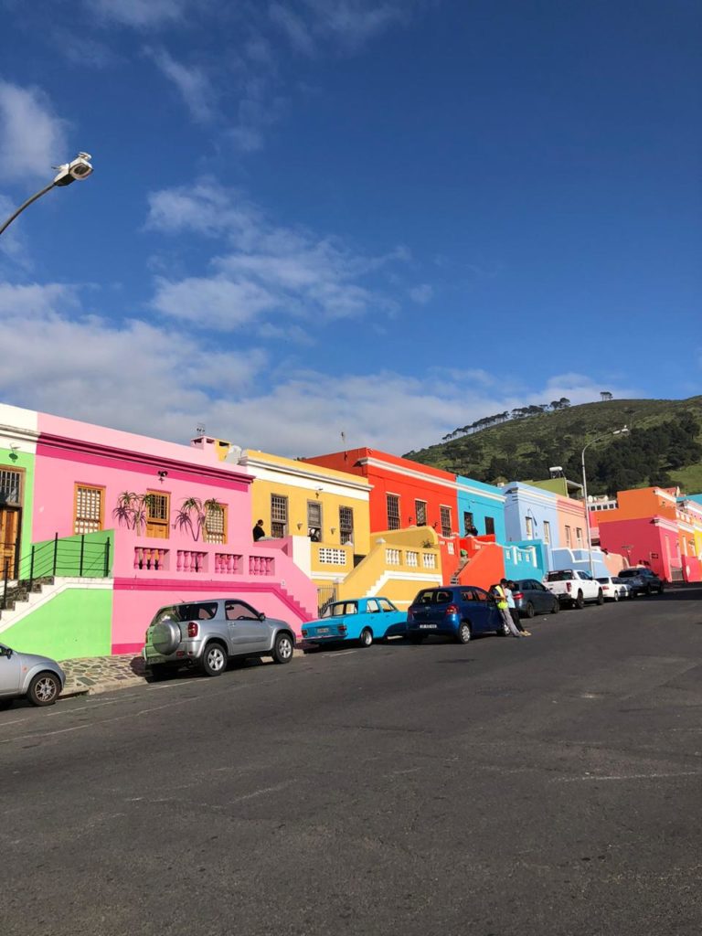 The colorful and unique neighborhood in Cape Town rests on a beautiful mountainous background on a warm spring morning.